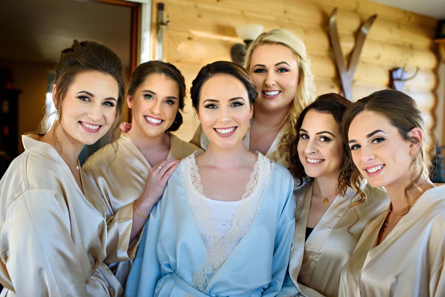 A happy bride poses with her bridesmaids.